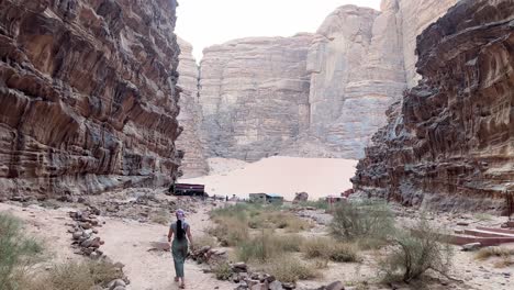 women in wadi rum canyon moving away in jordan