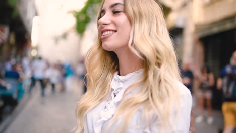 Slow,motion:Attractive-young-beautiful-girl-pulls-arm-of-her-boyfriend-at-narrow-street-in-Europe