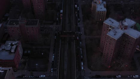 Stationary-drone-shot-of-train-tracks-in-Harlem,-New-York-City,-just-after-sunrise