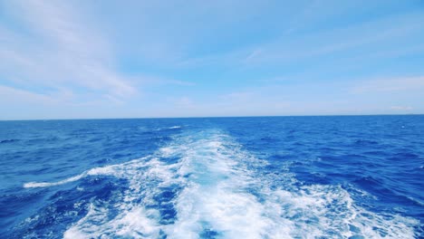 upper level view of wake behind yacht, tilt up revealing caribbean sea horizon