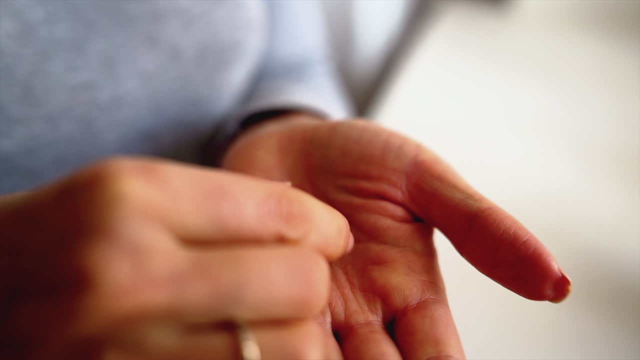Close up of a sick woman taking a pink pill