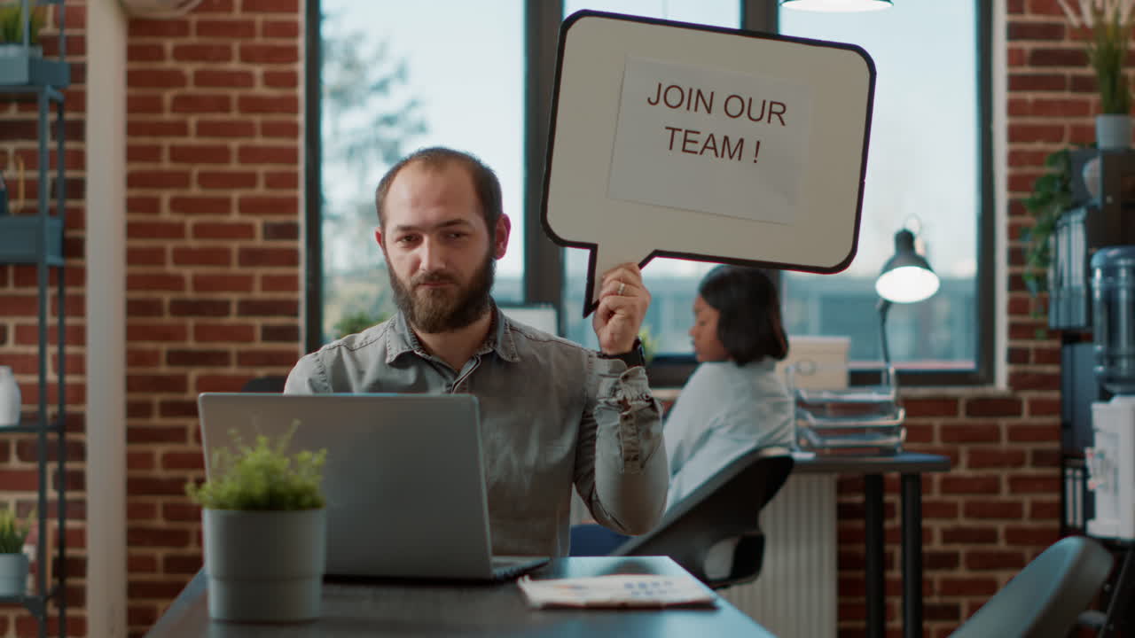 Portrait of male employee holding speech bubble to make job offer