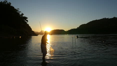 fisherman at sunset on a river
