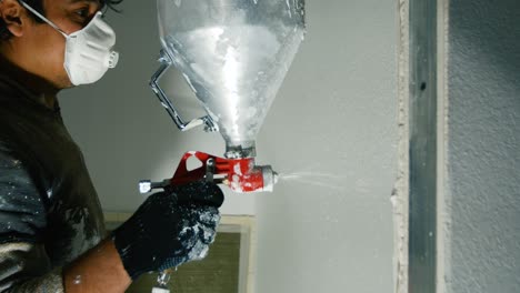 spray painting wall with plaster