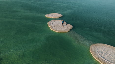 aerial view of person over salt formations on the amazing dead sea in israel