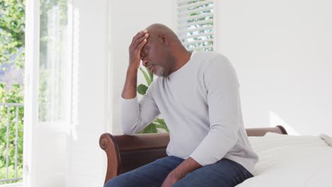 tired african american senior man having headache