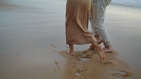 couple legs crossing ocean at summer closeup. people rest foggy coast together