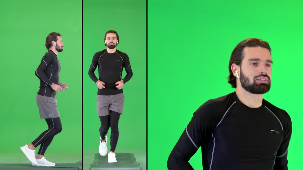 매력적인 스포츠맨이 음악을 듣고 무선 헤드폰을 착용하면서 녹색 스크린, 크로마 키에서 달리고 있습니다.