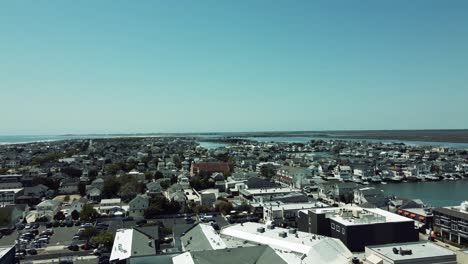 drone fly over the rooftops of the homes near the water in stone harbor, new jersey in the spring time