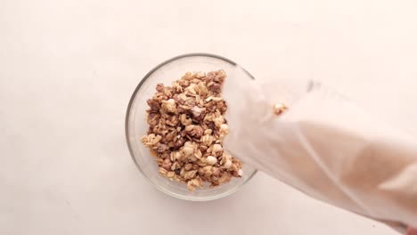 vertiendo granola en un cuenco