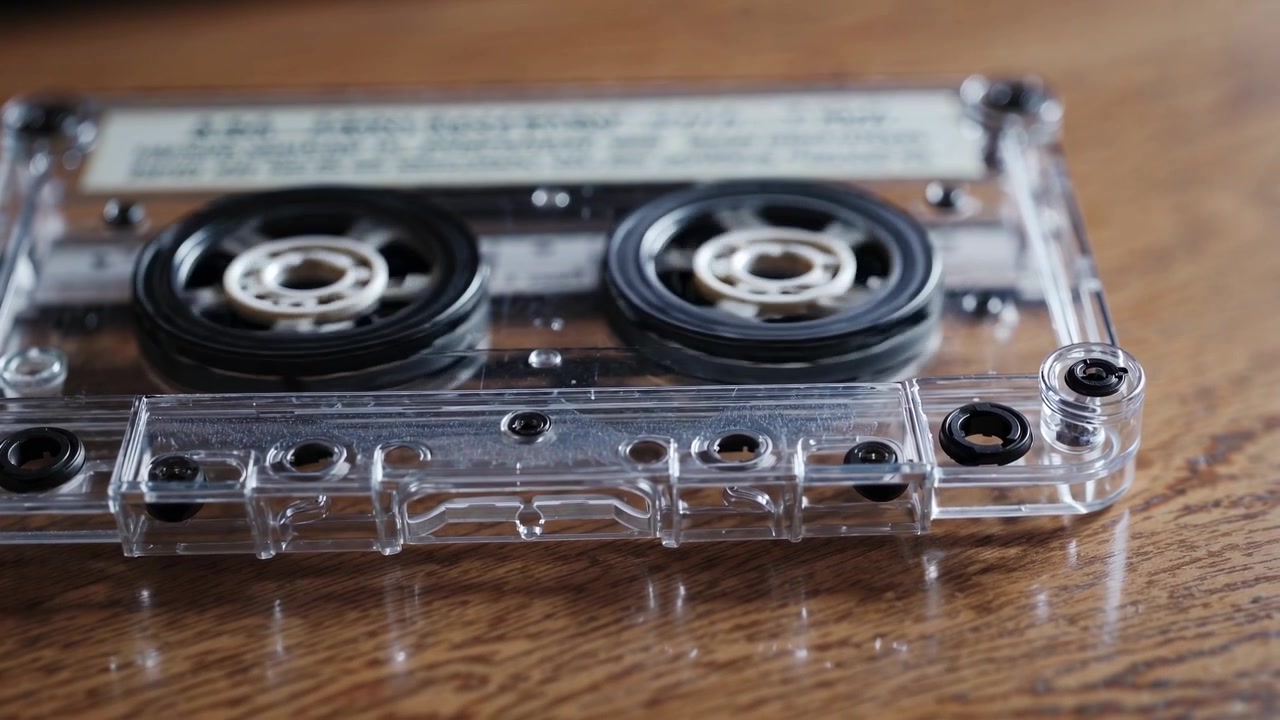 Vintage Cassette Tape Reels Spinning on a Wooden Table