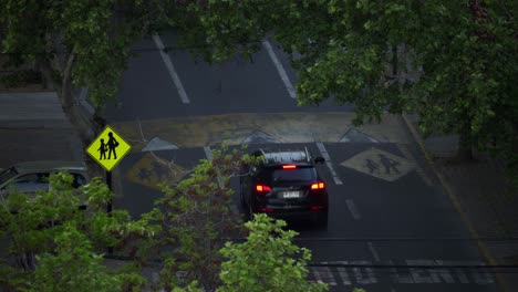 Schulzone-Voraus-Verkehrsschild-Mit-Autos,-Die-Auf-Der-Straße-Fahren