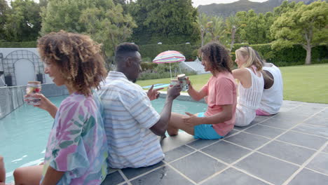 diverse group of friends enjoy a poolside gathering