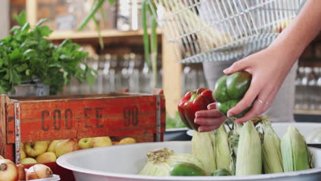 close up of young couple buying fresh fruit and vegetables in sustainable plastic free grocery store