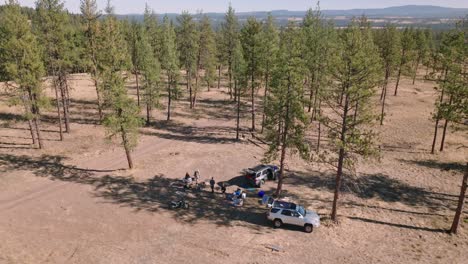 rising aerial view of friends car camping in oregon national forest