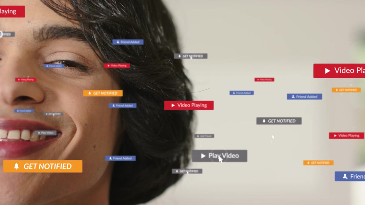 Adult male smiling while cursor clicking play spawning badges clustering near mouth for marketing