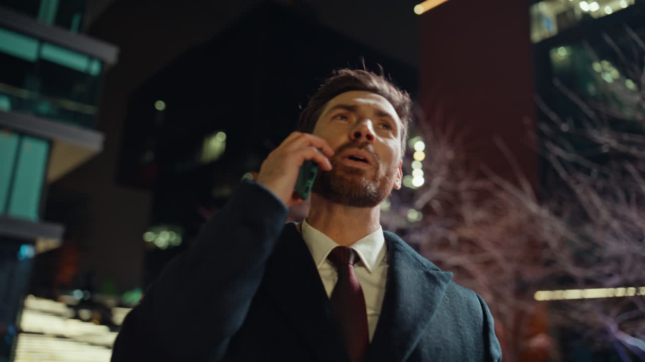 Overjoyed manager calling night business district closeup. Happy man talking