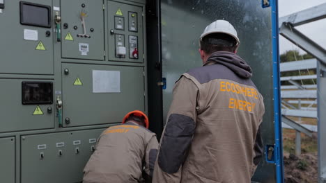 ecosphere energy workers inspecting solar panel equipment