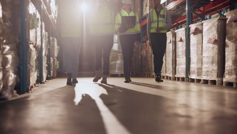 warehouse workers walking through aisles