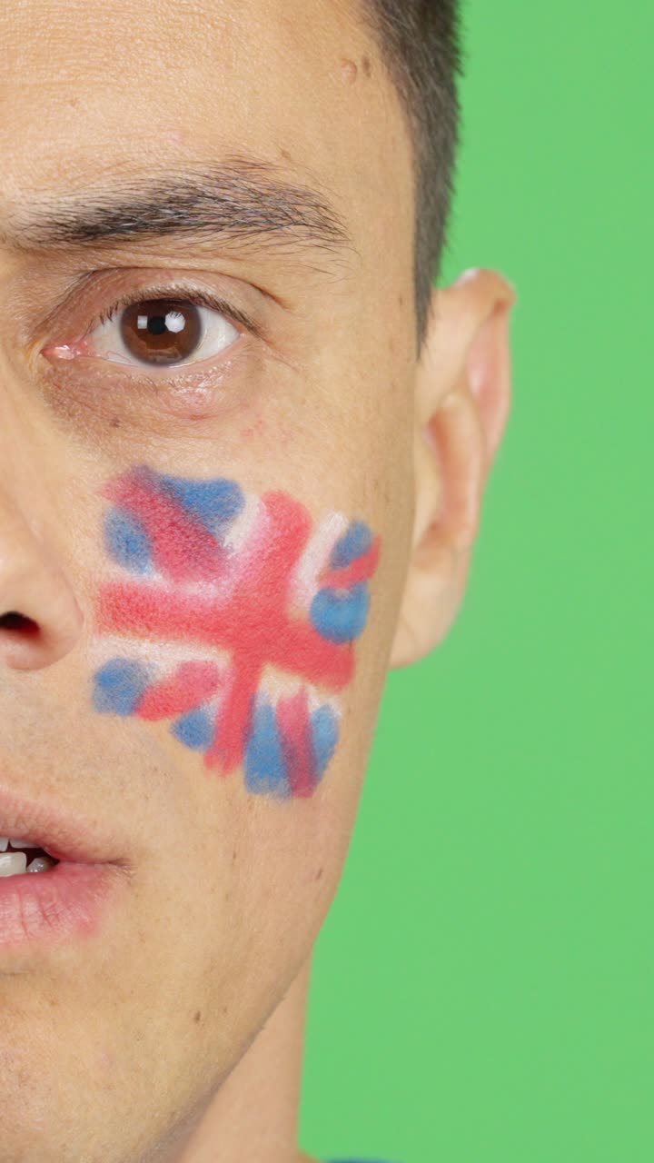 Man with a british flag painted on the face smiling