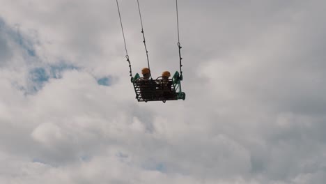 adventurous couple ride on swing at the end