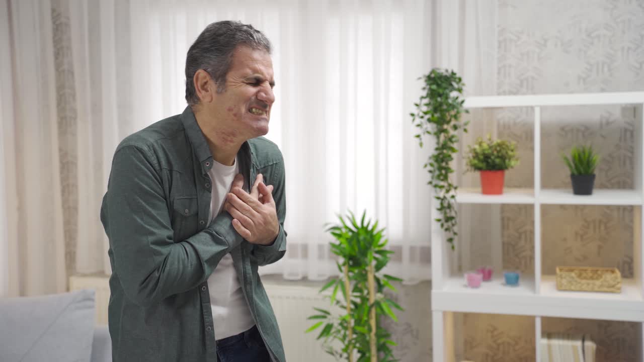 Sick mature man having a heart attack.