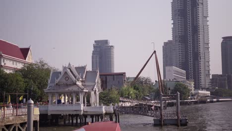 bangkok riverfront with temple and modern buildings