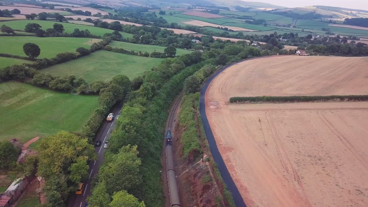 Aerial view of a train and road in the countryside