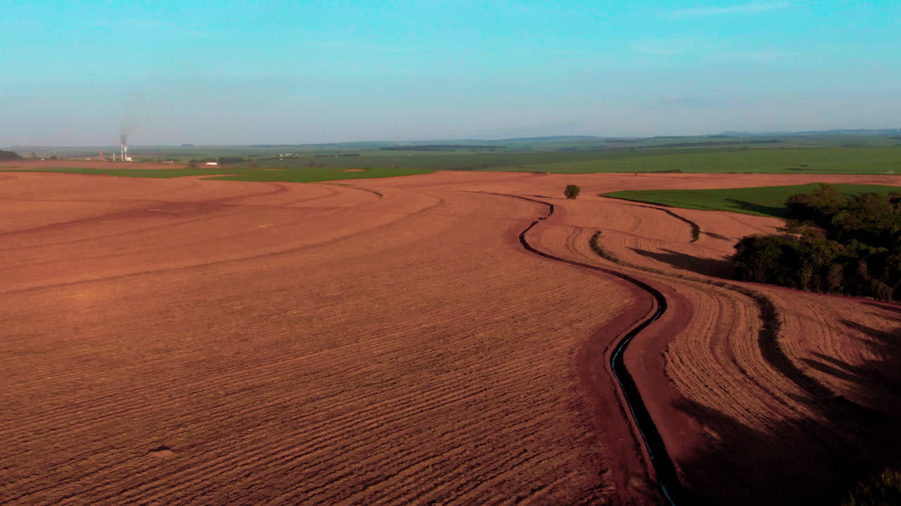 Drone aerial landscape over dirt ground and soil preparation for plantations crops in countryside farmland fields valley of Brazil South America industry agriculture production outdoors erosion