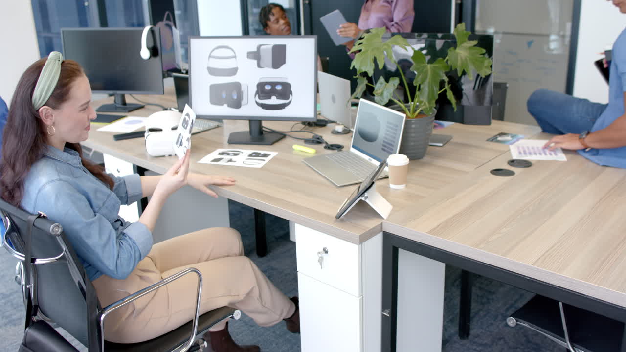 Team collaborating in modern office, discussing virtual reality headset designs