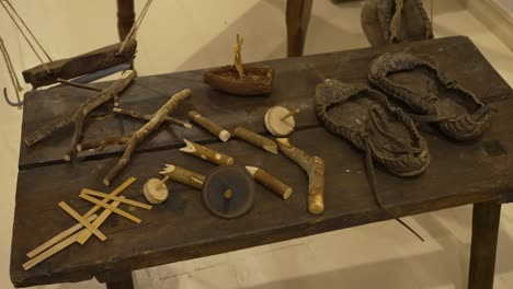 19th-century-toys-and-old-shoes-on-a-wooden-table