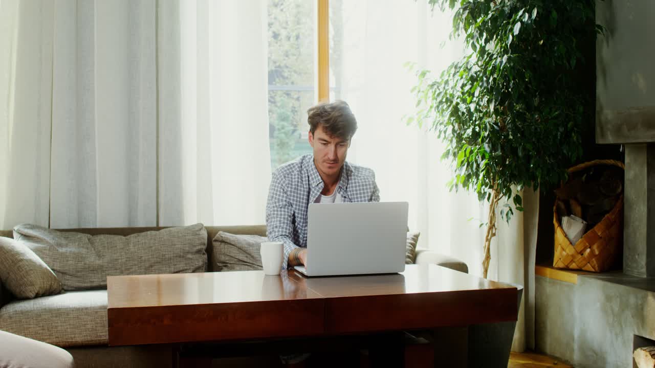 Man Working on Laptop at Home