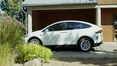 white electric car charging at home