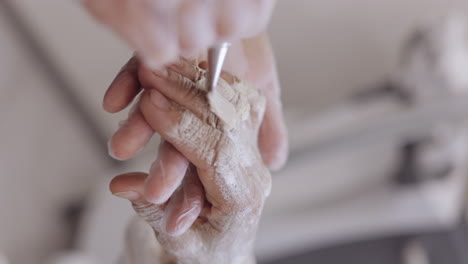 beautician applying moisturizing medical peeling cream on senior elderly woman hand, fingers, wrist