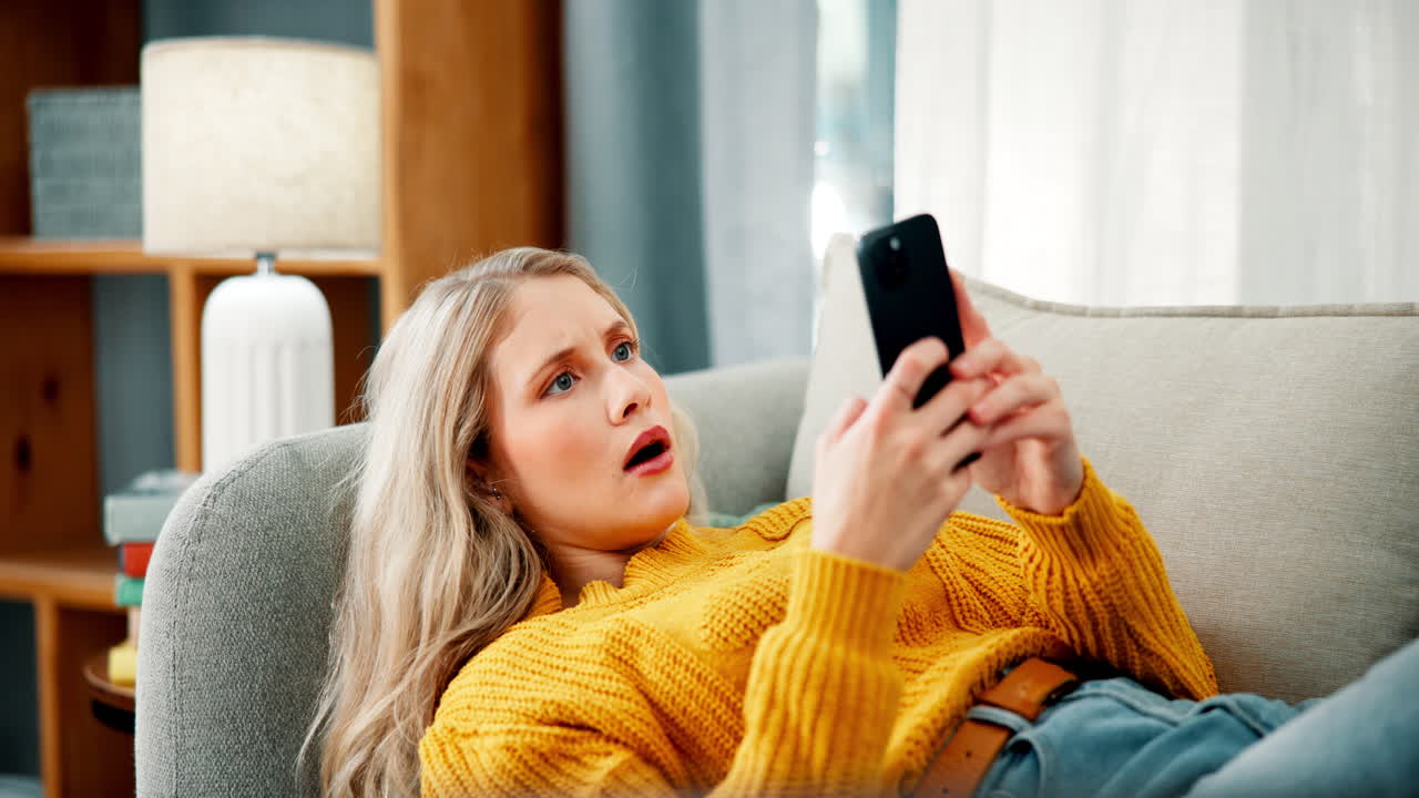 Woman looking at phone on couch