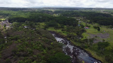 4k cinematic clockwise drone shot of a river flowing through a tropical jungle near hilo on the big island of hawaii