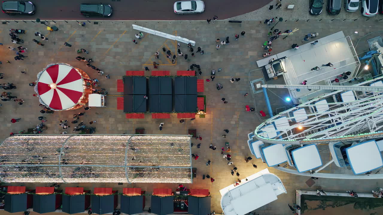 Top view urban festival with vibrant evening stalls. Crowds gather on promenade