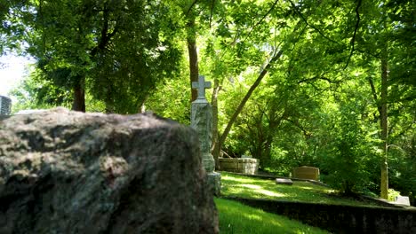 Panning-shot-of-old-tombstones-in-a-scary-overgrown-cemetery