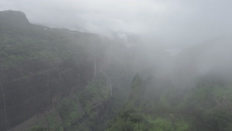 A-cinematic-aerial-drone-view-of-a-lush-green-rain-forest-on-the-hills-of-western-ghats-in-Andharban-forest-of-Pimpir-region-in-Maharashtra,-a-popular-trekking-destination-for-local-tourists