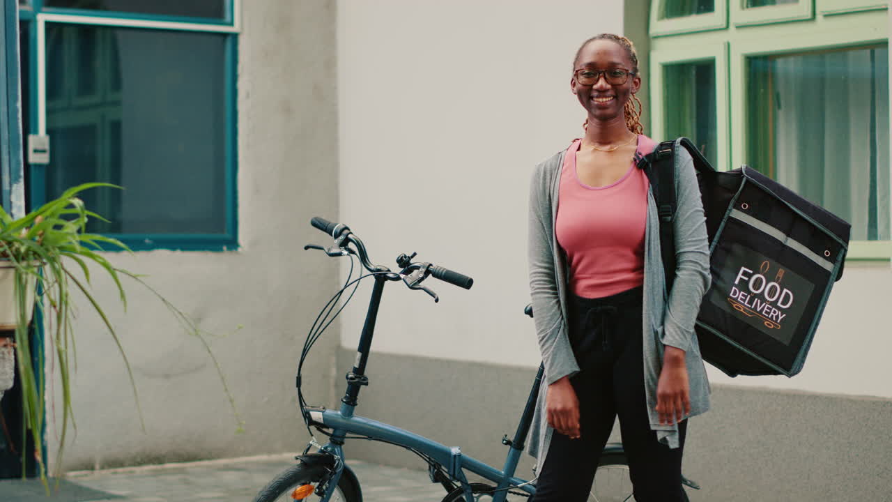 A woman is delivering food on a bicycle