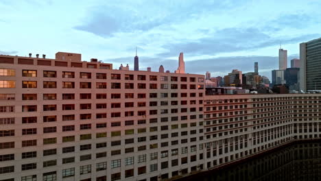 Aerial-view-rising-above-the-river,-revealing-the-Near-North-Side-skyline-of-Chicago