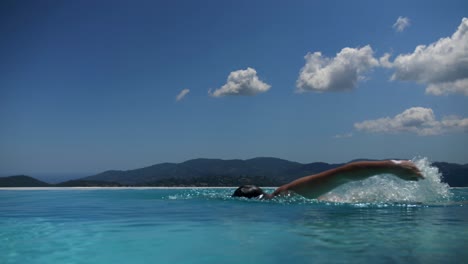 man swinming in pool during hot summer