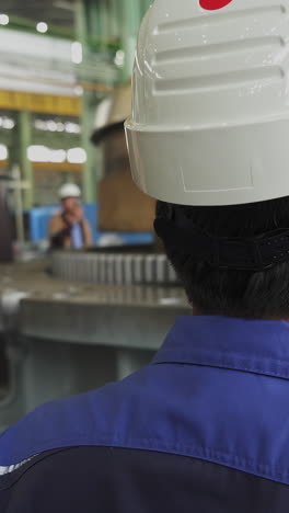 industrial workers observing machinery