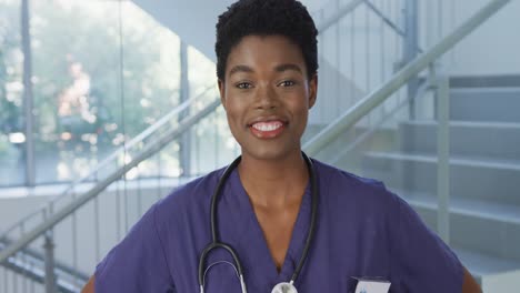 Portrait-of-happy-african-american-female-doctor-smiling-and-looking-at-camera-at-hospital