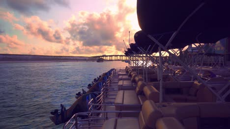 A-beautiful-sunset-over-a-harbor-with-boats-cruising-in-and-out