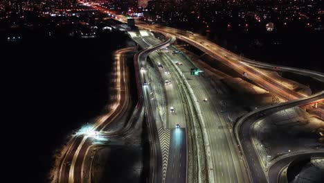 top down night city roads with cars driving aerial view. nightly urban cityscape with modern skyscrapers. majestic cityscape lit by neon lanterns lights with traffic highway. cinematic vehicle scenery