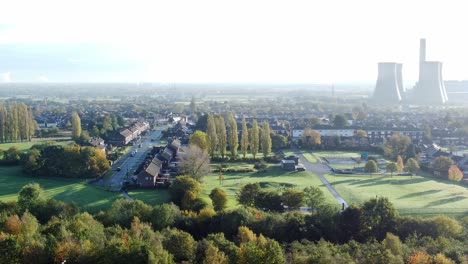 public green space fields fiddlers ferry bright glowing power station aerial view at sunrise left orbit slow