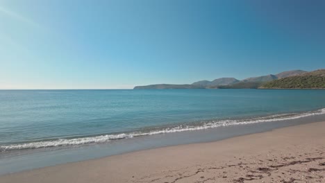 woman enjoys tranquil morning walking on deserted mediterranean beach