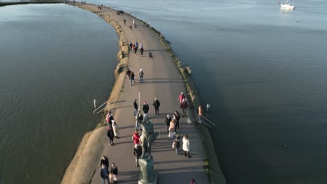 pullback over promenade with the statue of byrhtnoth near maldon town in essex, uk