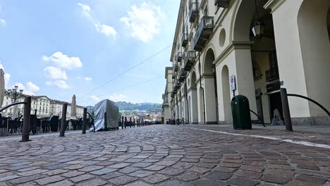 cobblestone street with covered objects and buildings